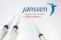 Three syringe next to the Janssen logo isolated on a white background