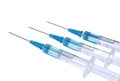 Three syringes with blue vaccine on white background Royalty Free Stock Photo