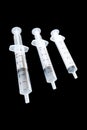 Three syringes isolated in black Royalty Free Stock Photo