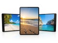 Three tablets with tropical beach scenes isolated on white background Royalty Free Stock Photo