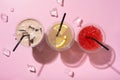 Three takeaway glasses of summer drinks with ice top view. Lemonade on colored background Royalty Free Stock Photo