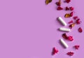 Three tampons with dry flowers on a purple background