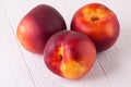 Three tasty fresh ripe juicy nectarines Royalty Free Stock Photo