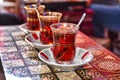Three tea glasses of traditional turkish tea with spoons on backgammon table Royalty Free Stock Photo