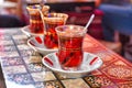 Three tea glasses of traditional turkish tea with spoons on backgammon table Royalty Free Stock Photo