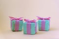 Three teal blue present boxes with bows. Winter holidays concept. Front view