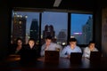 Three team working with computer overtime at night and low light Royalty Free Stock Photo