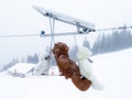 Three teddy bears with cute ties under an intense snowfall in the Swiss Alps