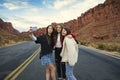 Three teen girls taking a selfie photo together outdoors with beautiful scenic red cliffs in the background. Royalty Free Stock Photo