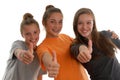 Three teenage girls all thumbs up smiling studio Royalty Free Stock Photo