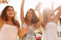 Three Teenage Girls Dancing Outdoors Against Sun Royalty Free Stock Photo