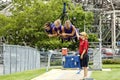 Three teenage Girls hanging from a ride at CedarPoint