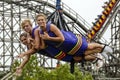 Three teenage Girls hanging from a ride at CedarPoint