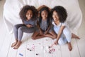 Three Teenage Sisters Giving Each Other Makeover In Bedroom
