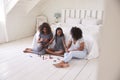 Three Teenage Sisters Giving Each Other Makeover In Bedroom