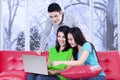 Three teenagers with laptop at home Royalty Free Stock Photo