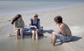 Three Teenagers Sitting at the Beach