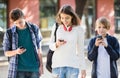 Three teenagers with smartphones in outdoors Royalty Free Stock Photo