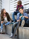 Three teenagers with smartphones in outdoors Royalty Free Stock Photo