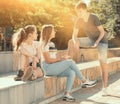 Three teenagers with smartphones are talking about play on walk Royalty Free Stock Photo