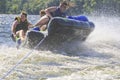 Three Teenagers on a Tube crashing Over a Wave