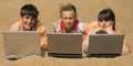 Three teens with laptops Royalty Free Stock Photo
