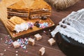 Three tender cake with coffee beans and bright powder on a gray wooden background. Selective focus, close up. background for postc Royalty Free Stock Photo