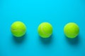 three tennis balls on bright blue background Royalty Free Stock Photo