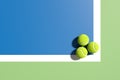 Three tennis balls at the corner of the lines on blue tennis court. 3D rendering. Flat lay overhead view