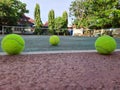 Three tennis balls on the edge of the tennis court Royalty Free Stock Photo