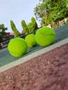 Three tennis balls on the edge of the tennis court Royalty Free Stock Photo