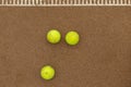 Three tennis balls lie side by side on a red clay court along. View from above Royalty Free Stock Photo