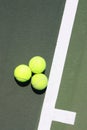 Three Tennis Balls On The Service Line