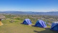 Three tents of blue on the high hills. Background blue sky and mountain Royalty Free Stock Photo