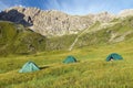 three tents on a meadow in the mountains Royalty Free Stock Photo