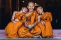 Buddhist novices sitting together feeling happy and smile Royalty Free Stock Photo