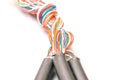 Three thick cables tangled in one big bundle of wires. Interlacing telecommunications telephone and Internet lines. Multi-colored Royalty Free Stock Photo