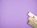 Three tied towels on a purple background