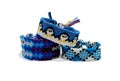 Three tied woven friendship bracelets with blue patterns. Handmade of floss thread, isolated on white background.