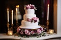 a three-tier fondant wedding cake with flower decorations Royalty Free Stock Photo