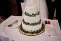 Three tier white wedding cake with decor and flowers