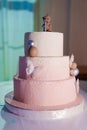 a three-tiered cake decorated with bear cub, caramel balls and butterflies. Royalty Free Stock Photo