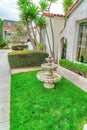 Three tiered fountain at the landscaped yard of house in Long Beach California