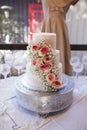 Three tiered wedding cake with roses Royalty Free Stock Photo