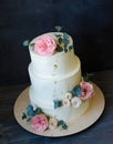 Three tiered wedding Cream cheese cake with roses and eucalyptus Royalty Free Stock Photo