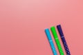 Three tilted colorful pen set on pink background