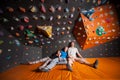 Three tired climbers on the mat near rock wall indoors Royalty Free Stock Photo