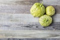 Three Tomatillos on Wooden Table Royalty Free Stock Photo