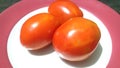 three tomatoes in a plate