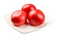 Three tomatoes on a square plate